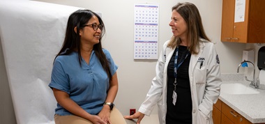 Dr. Margaret Callahan talking to a patient in an exam room