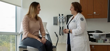 Woman talking to OBGYN