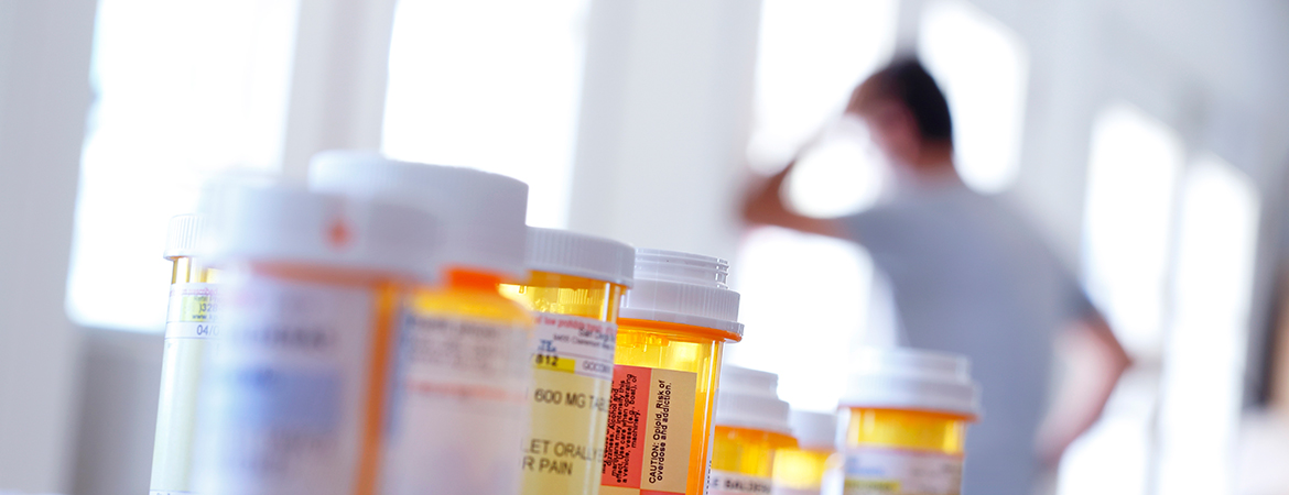 pill bottles with man in pain